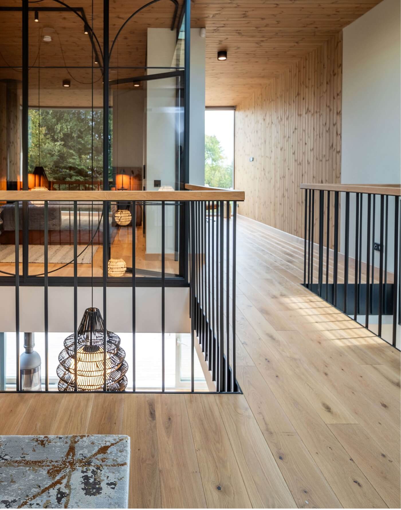 Nature inspired Coastal Interior Featuring Oak Wood Flooring, Earthy Colour Pallete and Captivating Forest Views